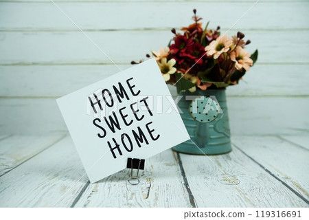 Home Sweet Home text message on paper card with flowers 119316691