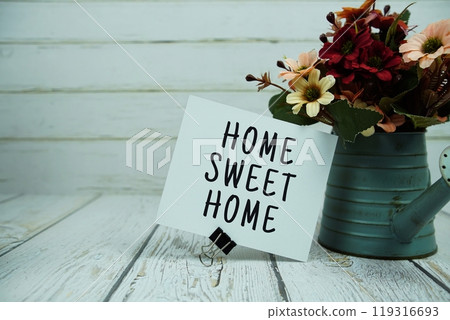 Home Sweet Home text message on paper card with flowers 119316693