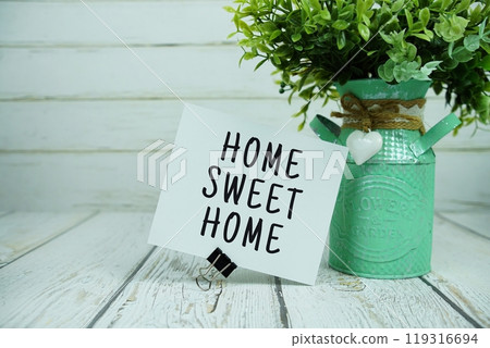 Home Sweet Home text message on paper card with artificial Home Sweet Home text message on paper card with artificial 119316694