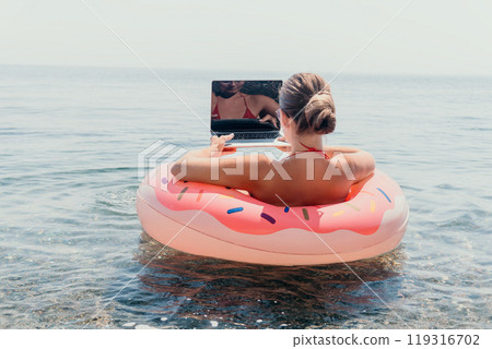 Woman Laptop Donut Float Beach Work Vacation 119316702