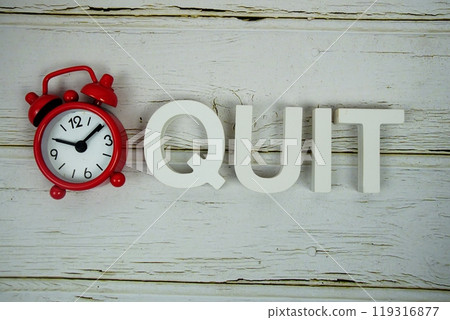 Quiz alphabet letters with alarm clock top view on wooden background 119316877