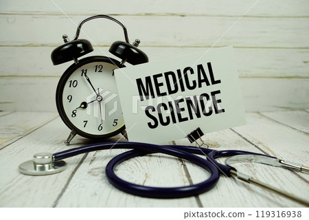 Medical Science text on paper card with alarm clock and stethoscope on wooden background 119316938