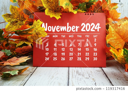 November 2024 monthly calendar with maple leaf decoration on wooden background for planning and management 119317416