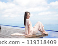 A smiling senior woman sitting on the wooden deck at Biwako Terrace with a spectacular view 119318409