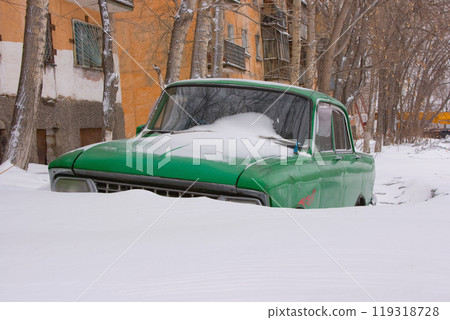 Old car in winter under the snow 119318728