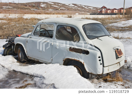 Old car in winter under the snow 119318729