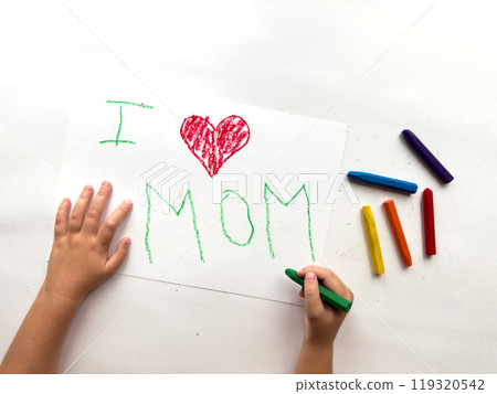 Childs hand draws heartfelt I love mom with colorful crayons on white paper 119320542