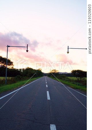 Sunset sky and straight road, Hokkaido 119320603