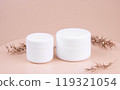 Two white jar for moisturizing cream with a on pink or peach background. Mockup for branding product packaging.High quality photo 119321054