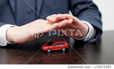 Hands of a businessman protecting a car 119321485