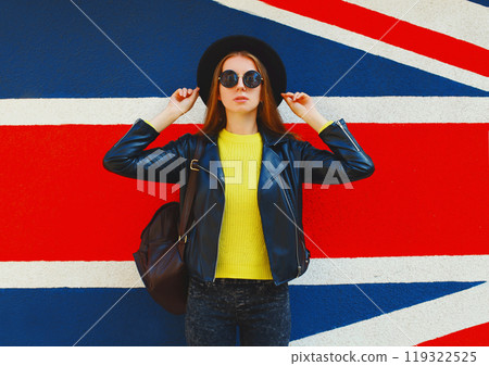 Fashion pretty woman in black rock style posing over colorful background 119322525