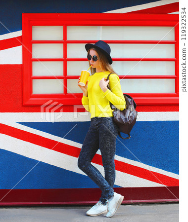 Fashion young woman model with cup over colorful urban backgroun Fashion young woman model with cup over colorful urban backgroun 119322534