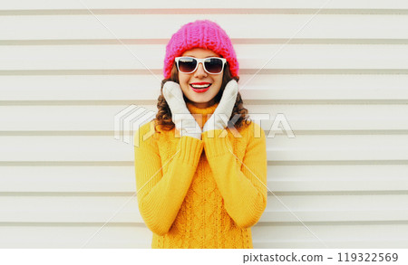 happy smiling woman having fun wearing colorful knitted pink hat over white background happy smiling woman having fun wearing colorful knitted pink hat over white background 119322569