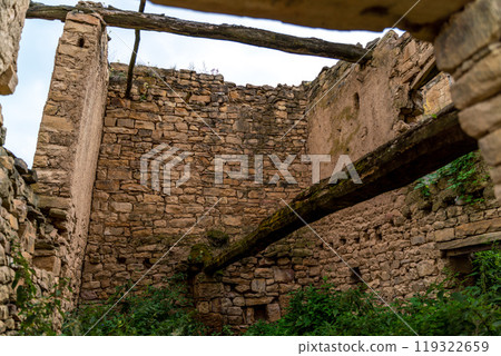 Dagestan Gamsutl. Ancient ghost town of Gamsutl old stone houses in abandoned Gamsutl mountain village in Dagestan, Abandoned etnic aul, summer landscape. 119322659
