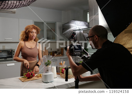 Cameraman Shooting Model In Domestic Kitchen Cameraman Shooting Model In Domestic Kitchen 119324158