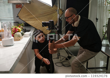 Cameraman Setting Equipment Before Shooting 119324178
