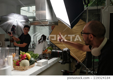 Operator Setting Camera With His Colleague 119324184