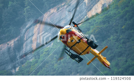 Securite Civile or a civil defense agency helicopter on a rescue mission in the French Alps 119324508