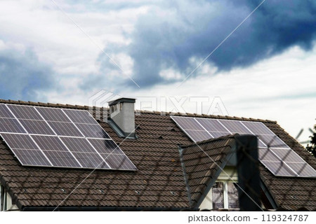Historic farm house with modern solar panels on roof and wall 119324787
