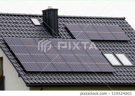 Historic farm house with modern solar panels on roof and wall 119324801