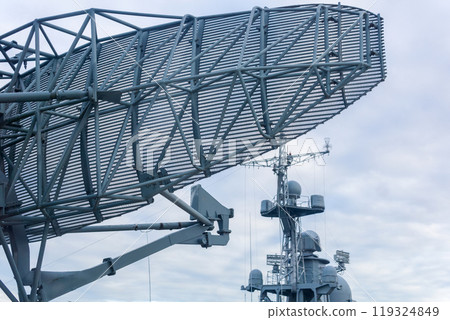 military background, naval radar antenna close up and warship in the background 119324849