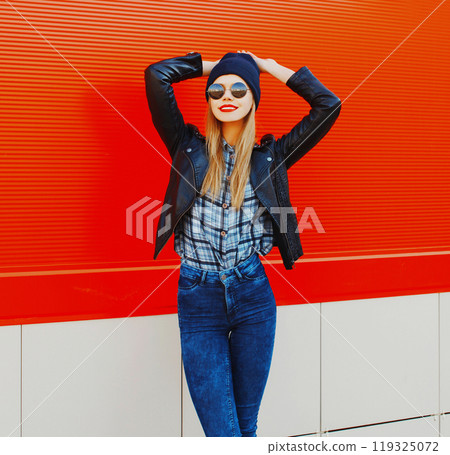 Fashion portrait beautiful blonde smiling woman model in rock black style on red background 119325072