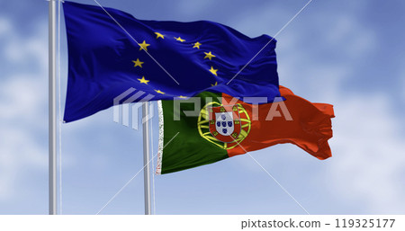 Close-up of Portugal and the European Union flags waving on a clear day Close-up of Portugal and the European Union flags waving on a clear day 119325177