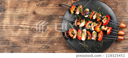 A plate of octopus skewers. 119325451