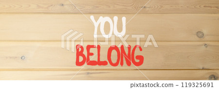 Belonging and you belong symbol. Concept words You belong on beautiful wooden wall. Beautiful wooden wall background. Business belonging and you belong concept. Copy space. Belonging and you belong symbol. Concept words You belong on beautiful wooden wall. Beautiful wooden wall background. Business belonging and you belong concept. Copy space. 119325691