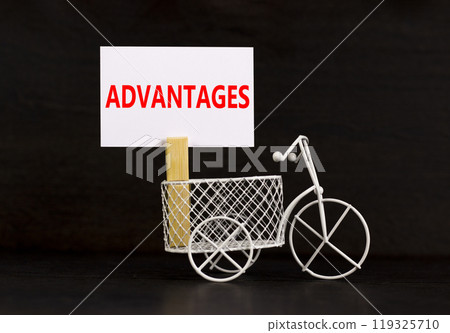 Advantages symbol. Concept word Advantages on beautiful white paper on clothespin. Beautiful black background. Beautiful miniature white bicycle. Business advantages concept. Copy space. 119325710