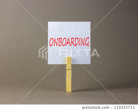 Onboarding success symbol. Concept word Onboarding on beautiful white paper on clothespin. Beautiful grey background. Business onboarding success concept. Copy space. 119325713