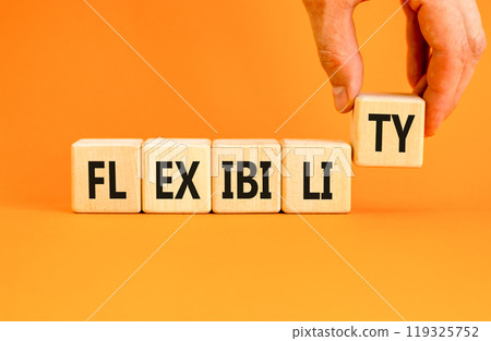 Flexibility symbol. Concept word Flexibility on beautiful wooden blocks. Beautiful orange background. Businessman hand. Business flexibility concept. Copy space. 119325752