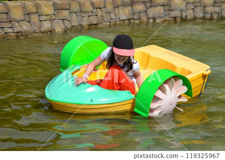 Kid playing rowing water paddle boat. Soft focus. . High quality photo Kid playing rowing water paddle boat. Soft focus. . High quality photo 119325967