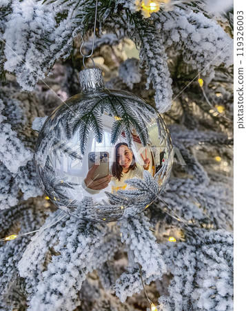 smiling women reflection in christmas tree toy smiling women reflection in christmas tree toy 119326003
