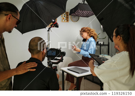 Crew Working With Model In Studio 119326150