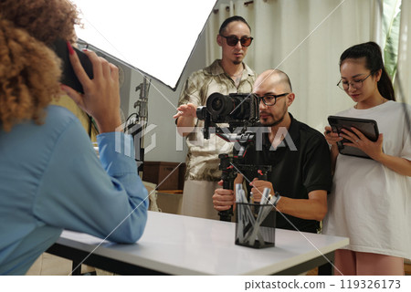 Cameraman Shooting Model On Camera 119326173