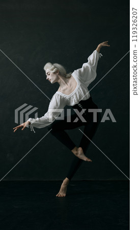 Dynamic portrait of young ballet dancer dressed old garment and wig, leaping gracefully in motion against vintage style background. 119326207