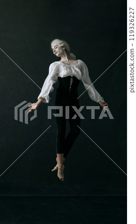 Floating effortlessly, ballet dancer, dressed noble look, embodies both vintage style and modern athleticism. Graceful choreography. 119326227