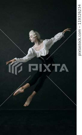 Dynamic photo nobleman blends elegance with modern athleticism in his ballet performance against vintage style background. 119326234