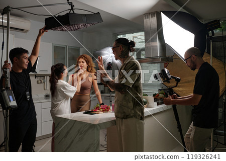 Stylist Preparing Model For Shooting In Studio 119326241