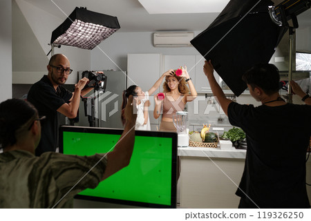 Crew Working With Model In Studio 119326250