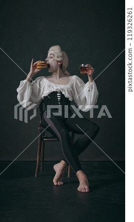 Man, delicately balances burger and drink, dressed in 18th-century style. It's playful mix of eras, blending historical with modern fast food culture. Man, delicately balances burger and drink, dressed in 18th-century style. It's playful mix of eras, blending historical with modern fast food culture. 119326261