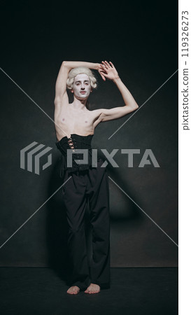 Young man, medieval character posing, exudes aura of aristocratic charm fused with modern avant-garde style against vintage background. 119326273