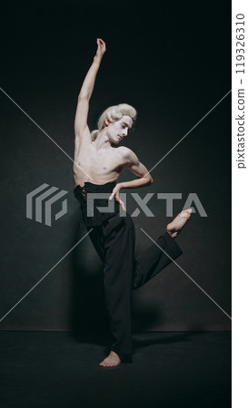 Young man with make-up, dances through time, performing dynamic fusion of classical movement and modern fashion aesthetics. Young man with make-up, dances through time, performing dynamic fusion of classical movement and modern fashion aesthetics. 119326310