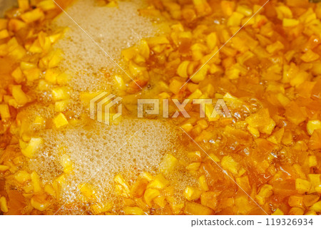 sliced yellow apples boiling in syrup during confiture cooking sliced yellow apples boiling in syrup during confiture cooking 119326934
