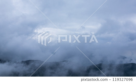 Clouds hanging over the mountain peak on a rainy day Clouds hanging over the mountain peak on a rainy day 119327096