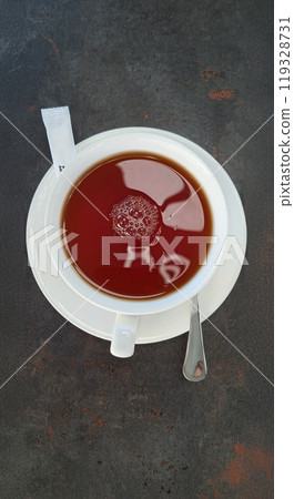 Close up shot of hot latte coffee with latte art in a ceramic white cup and saucer on white background 119328731