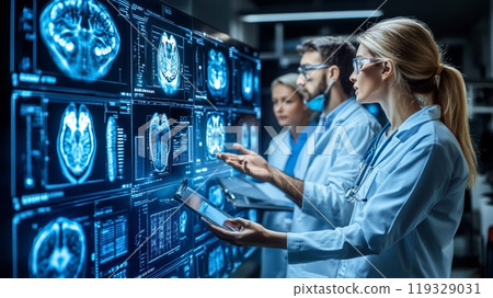 Medical professionals analyzing brain scans on digital screens in a lab setting. 119329031