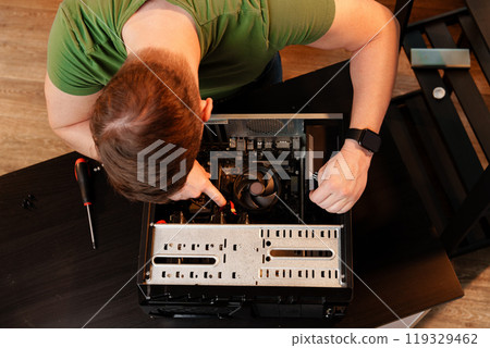 Close up of man repairing computer system unit 119329462