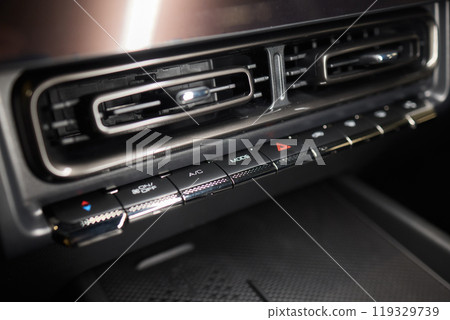 Closeup of car dashboard air vents near gear shift 119329739